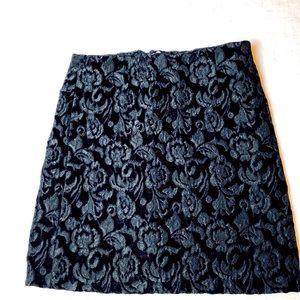 Black “upholstery fabric” lined black textured mini skirt
